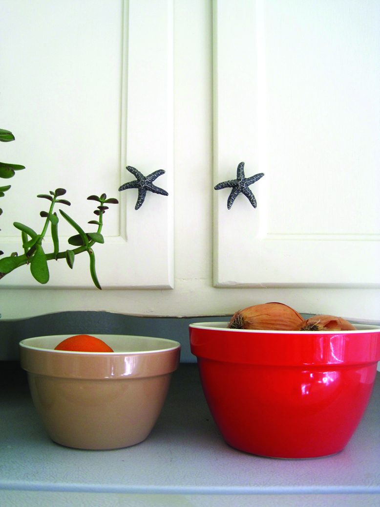 Atlas Homewares starfish knobs on white cabinets