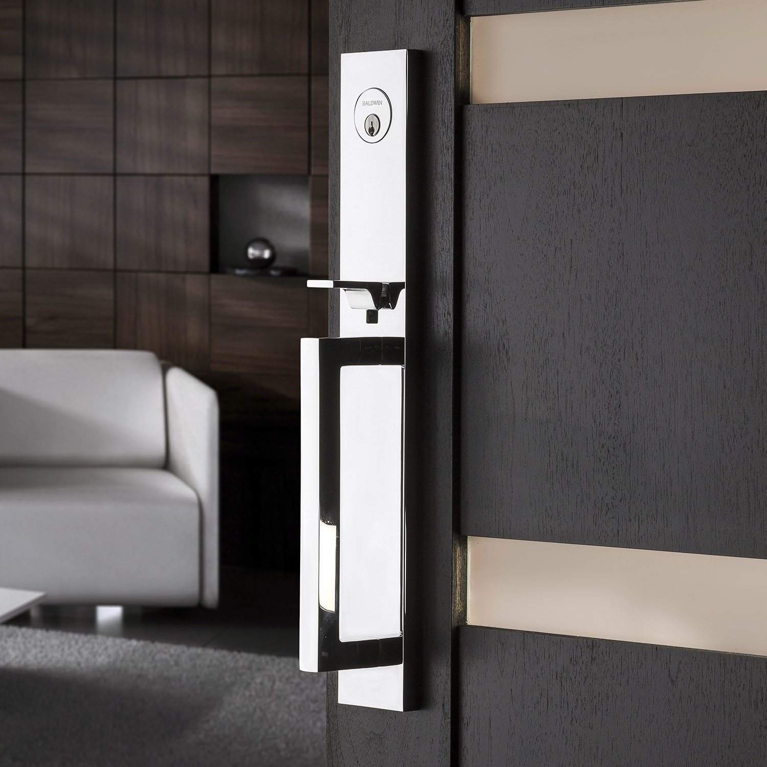 Baldwin chrome handleset on a dark modern entry door