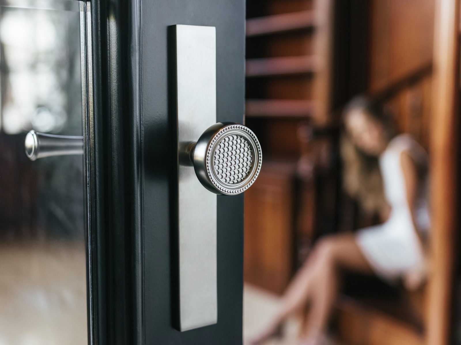 Baldwin chrome knob and backplate on a black front door
