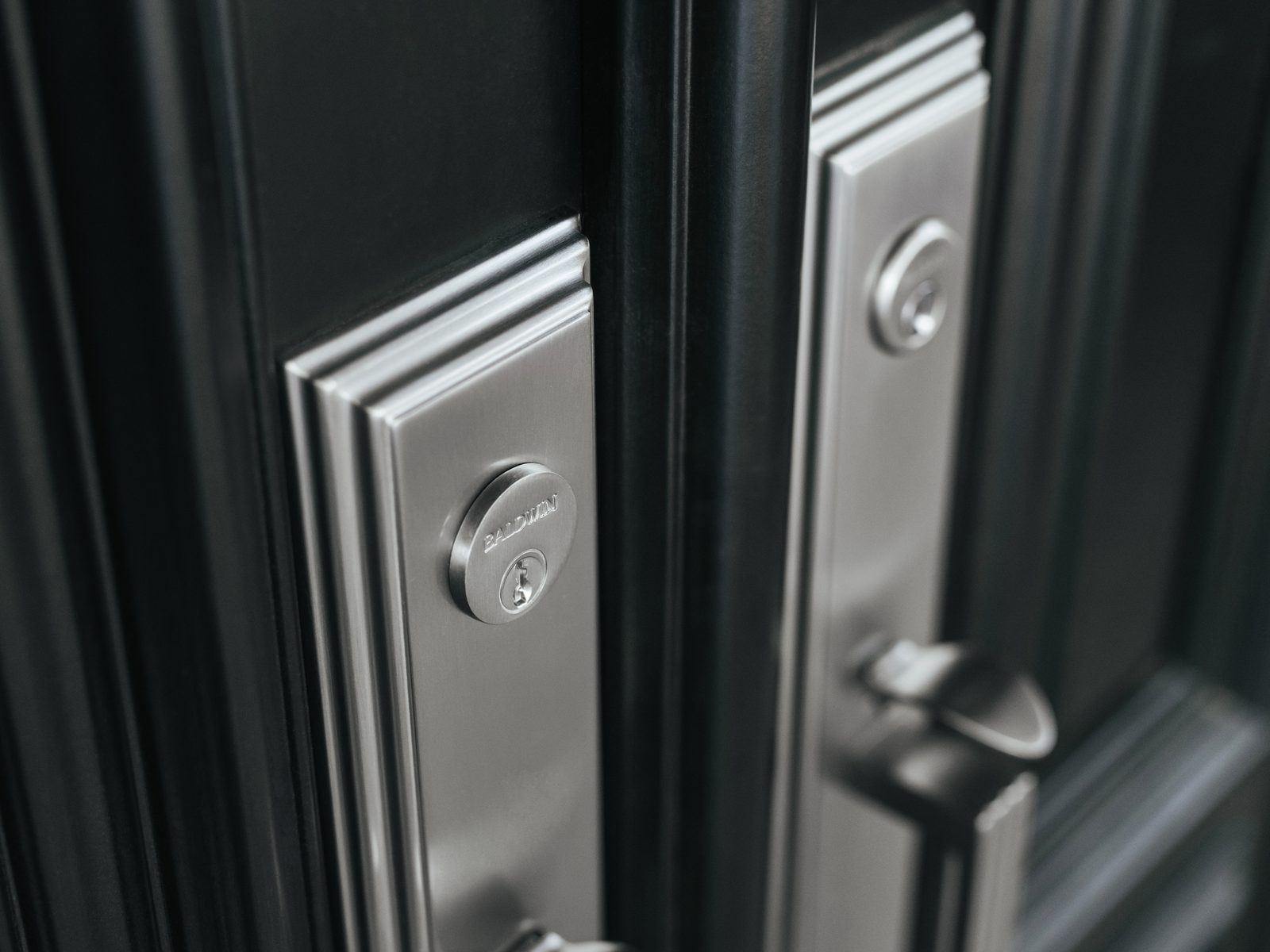 Baldwin polished chrome lever and deadbolt on a black door