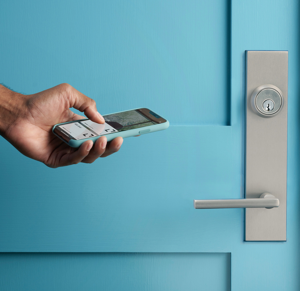 Omnia satin lever and deadbolt on a teal door with smart access