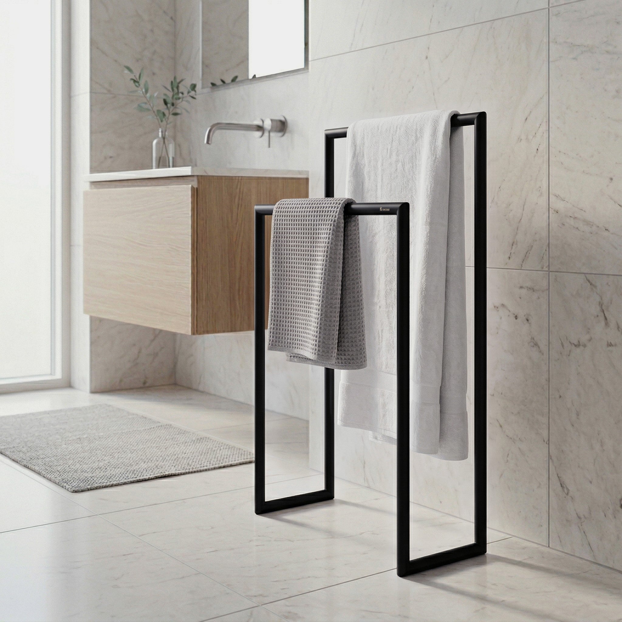 Smedbo matte black towel stand in a marble bathroom