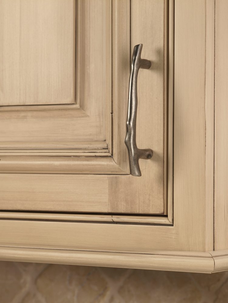 Top Knobs Aspen twig pull on a cream cabinet door
