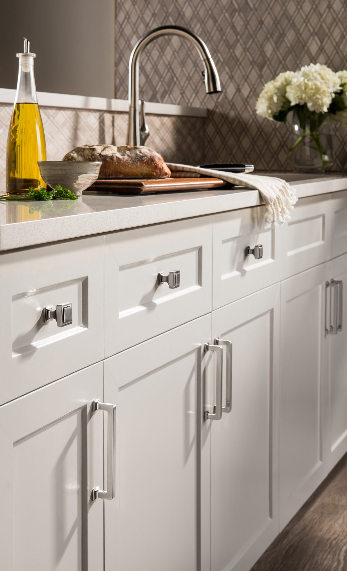 Top Knobs Transcend chrome hardware in a white kitchen