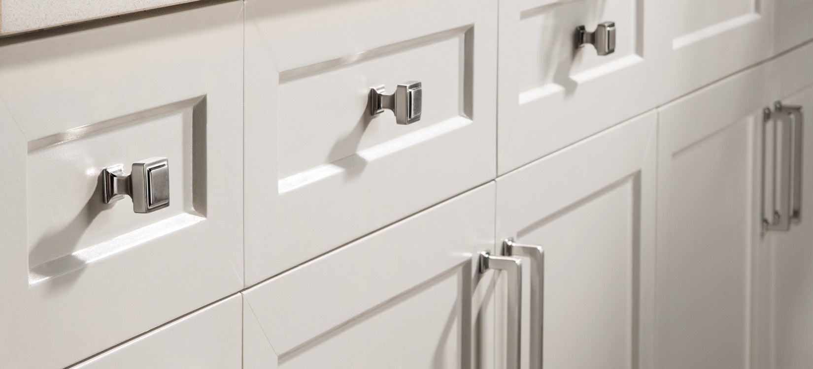 Top Knobs Transcend polished nickel knobs on white cabinets
